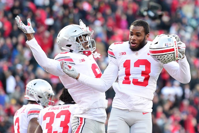 Nov 17, 2018; College Park, MD, USA; Ohio State Buckeyes cornerback Kendall Sheffield (8) and cornerback Tyreke Johnson (13) celebrate on the field after defeating Maryland Terrapins in overtime at Capital One Field at Maryland Stadium. Mandatory Credit: Tommy Gilligan-USA TODAY Sports