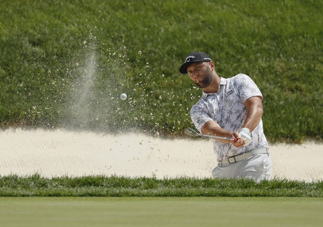 Jon Rahm hits onto the 9th green during the third round of the Memorial Tournament on June 5. He led by six strokes after the round but had to withdraw because of positive COVID test.