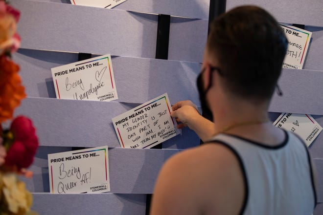 Ashton Colby fills out a "What Pride means to me" card during Columbus Stonewall's Tea Dance in Columbus in June.