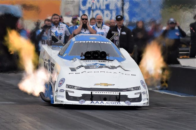 NHRA Funny Car legend John Force races down the track on his way to his 153rd race win at Sunday's NHRA New England Nationals in Epping.