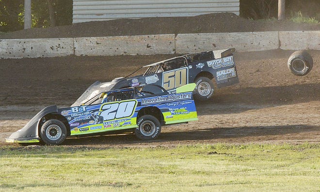 Watertown's Tim Waba (50) loses a wheel as he battles fellow Watertown driver Trevor Walsh for position during a late-model heat race during Sunday night's weekly racing program at Casino Speedway.