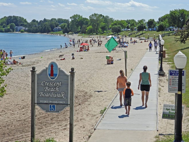 Visitors stroll down the boardwalk on Crescent Beach in Algoma. The Greater Green Bay Community Foundation awarded a grant to Friends of Crescent Beach, a community volunteer support organization, to help fund restoration and education efforts.