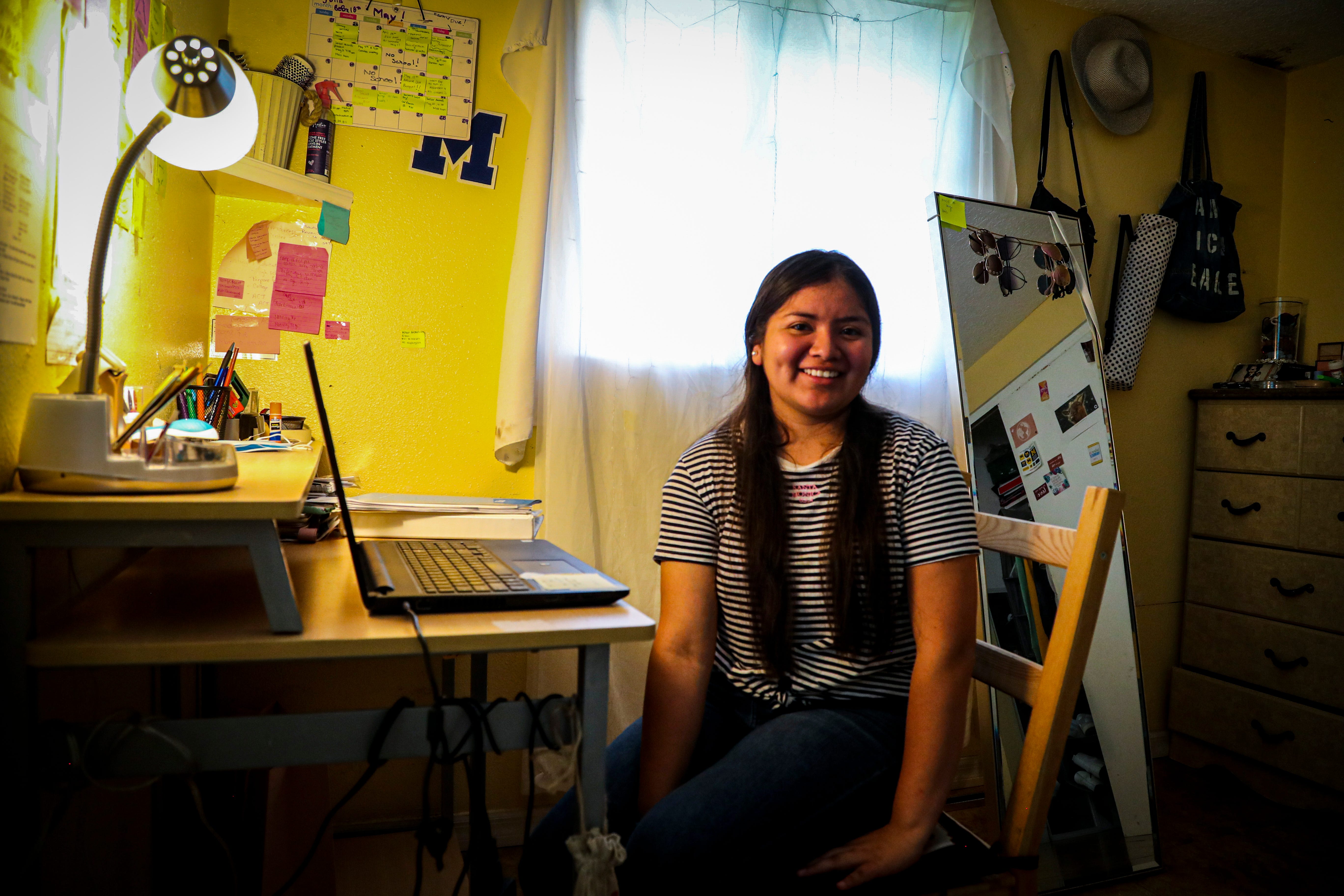 Luz Vazquez Hernandez in her room in Mulberry, Florida. This is where she spent most of her time working on homework during the pandemic. She was taking three AP classes during virtual school, which she balanced with working during the school day in the fields. This year she graduated with a 3.9 GPA.