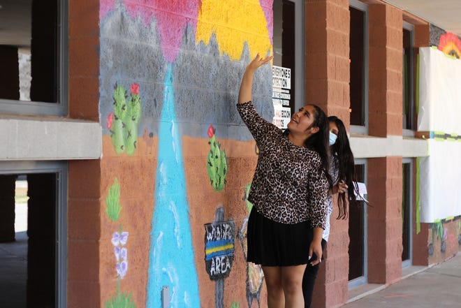 Tahlor Triolo explains her work on the mural "Preserve Wildlife" at an unveiling at Organ Mountain High School on Monday, June 14, 2021. During extended learning time, OMHS partnered with Cruces Creatives, a local group that provides supplies and space for creativity through art, to teach students about the history of spray painting.