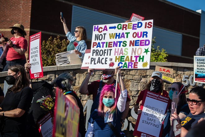 Hundreds of nurses and community members filled the sidewalks and seating area surrounding Mission Hospital during a picket on Tuesday, June 15, 2021. Chants called for 'safer staffing' and 'fair contracts' from hospital owner HCA Healthcare.