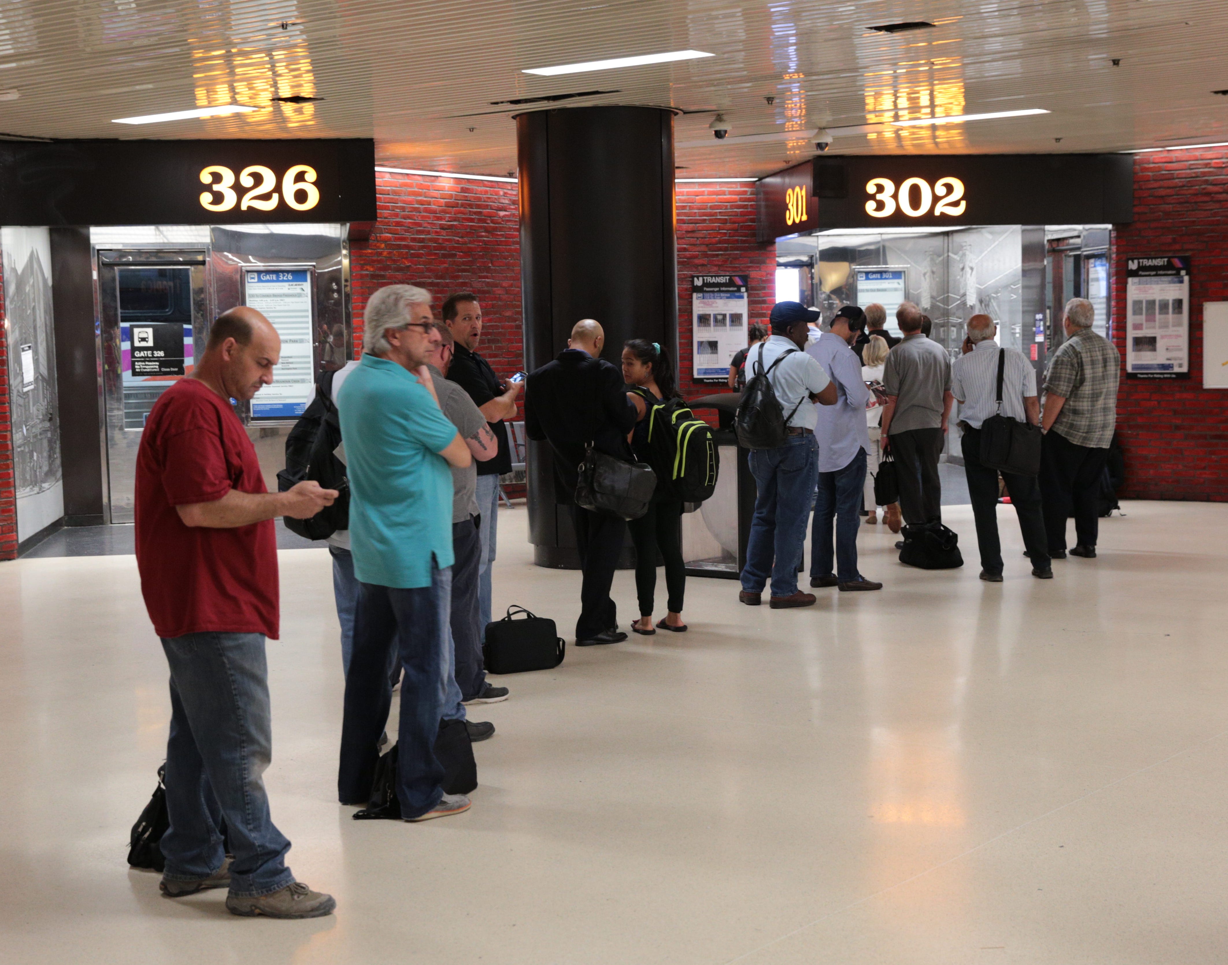 Commuters line up for a bus on the third floor at the Port Authority Bus Terminal in midtown. The Port Authority restructured departure gates in order to ease congestion during rush hour. Aug. 10, 2015.