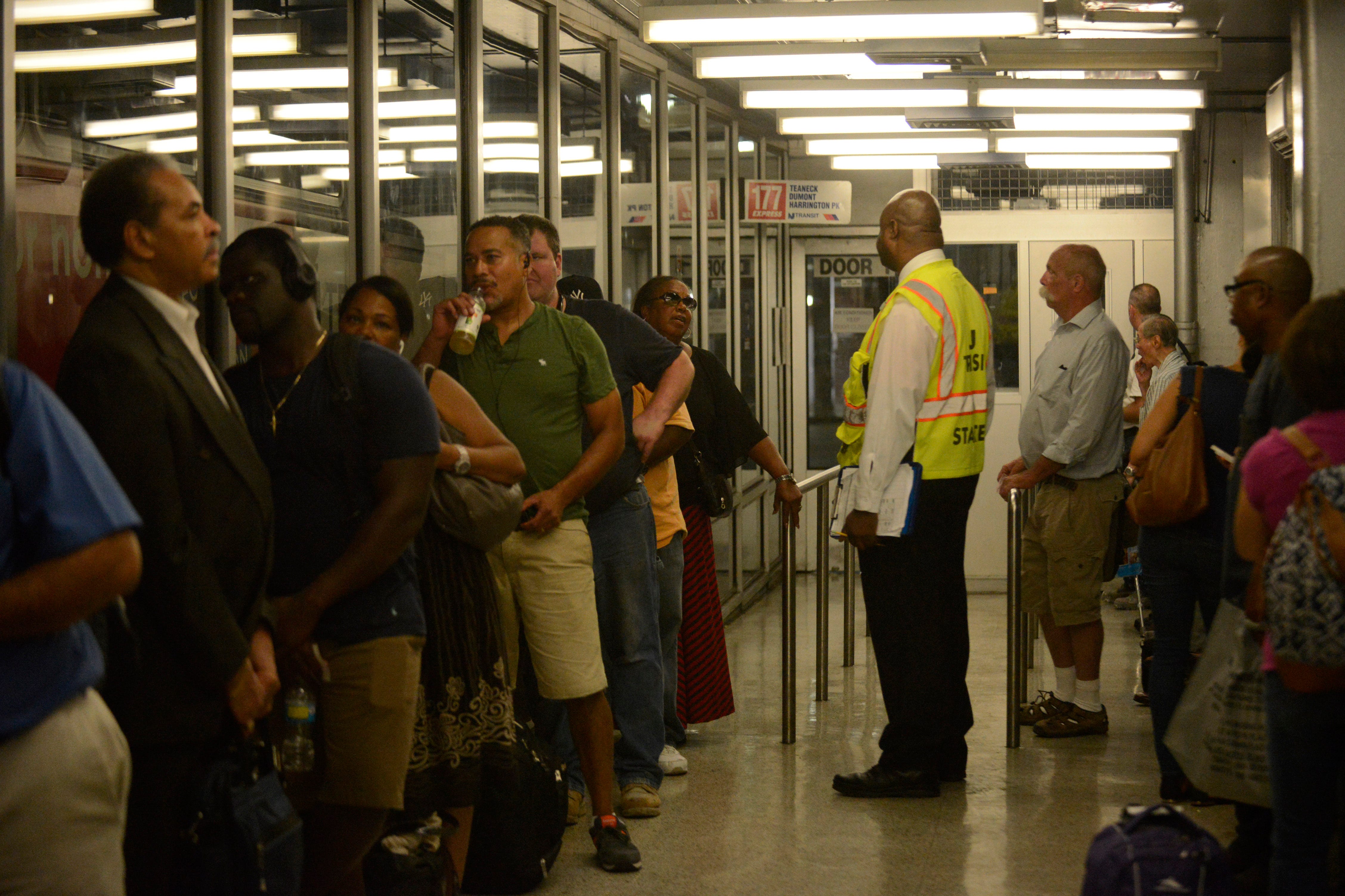 Commuters wait to get on the bus at the Port Authority Bus Terminal on the first day of new gate assignments, part of the agency's efforts in 2015 to reduce congestion and delays by getting buses through the building more efficiently. Sept. 8, 2015