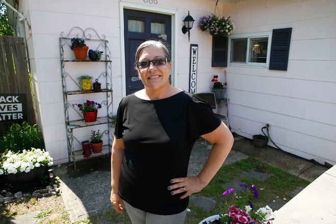 Thea Gleason stands in front of her family's Little Egg Harbor home. Her family delayed mortgage payments for a year during the pandemic, and are unsure what her mortgage company will require of them once the forbearance period ends.