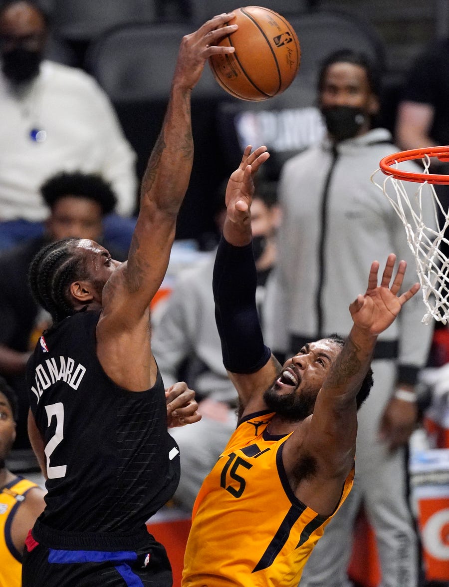 Second round: The Los Angeles Clippers' Kawhi Leonard dunks over the Utah Jazz's Derrick Favors during Game 4 at Staples Center. The Clippers won the game, 118-104, to tie up the series at two games apiece.
