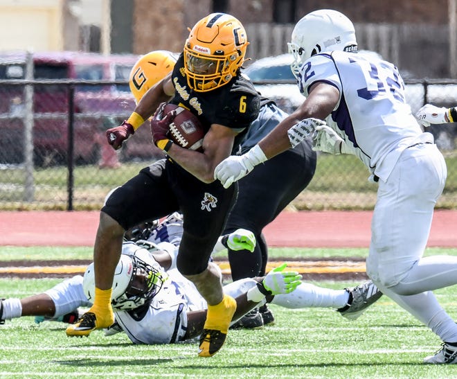 Garden City Community College running back Jordan Ford, left, breaks through an attempted tackle by Arkansas Baptist's Jordan Oglesby and picks up 30 yards on a carry in March at Bronbuster Stadium.