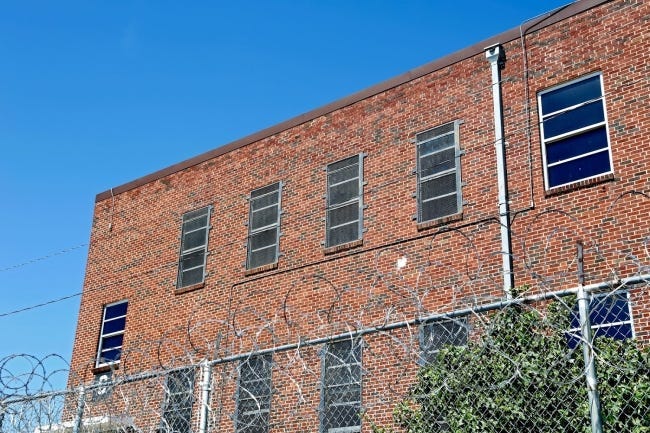 A razor-wire fence wraps around the William S. Key Correctional Center in Fort Supply. The minimum-security prison houses mostly nonviolent drug offenders in dormitory-style housing units.