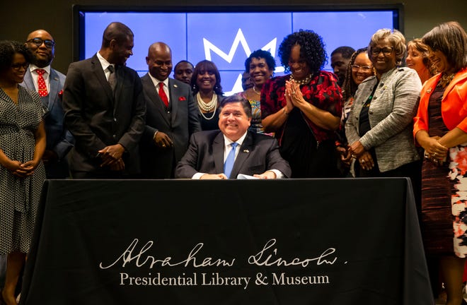 Illinois Gov. JB Pritzker signs the bill making Juneteenth an official state holiday in Illinois during a ceremony at the Abraham Lincoln Presidential Library in Springfield, Ill., Wednesday, June 16, 2021. [Justin L. Fowler/The State Journal-Register] 