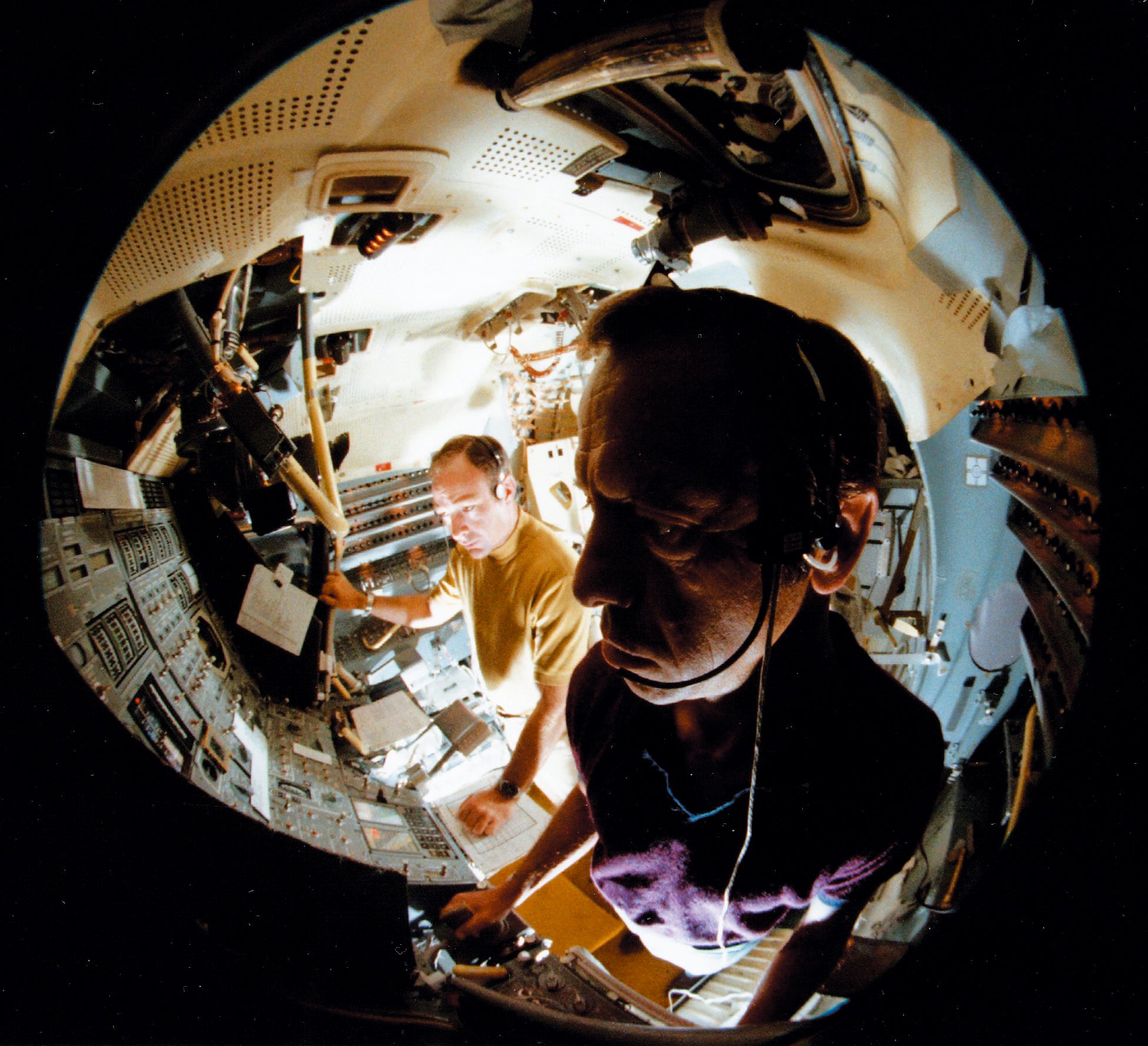 A fish-eye lens view shows Apollo 14 mission US astronauts Alan B. Shepard Jr. (foreground) and Edgar D. Mitchell working in a LM (lunar module) simulator at Kennedy Space Center, Florida on July 15, 1970. The Apollo XIV mission, the third mission to land on the moon, was launched on January 31, 1971 and landed on the moon on February 5, 1971.