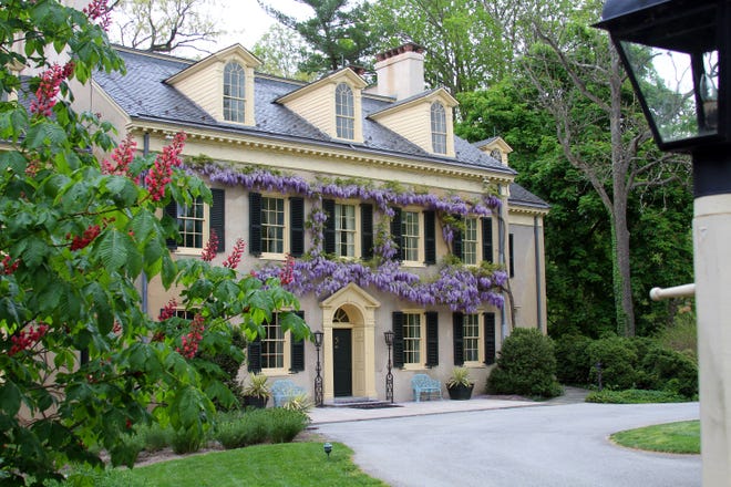 Wisteria grows on the residence at Hagley Museum and Library in this May 7, 2013, file photo.