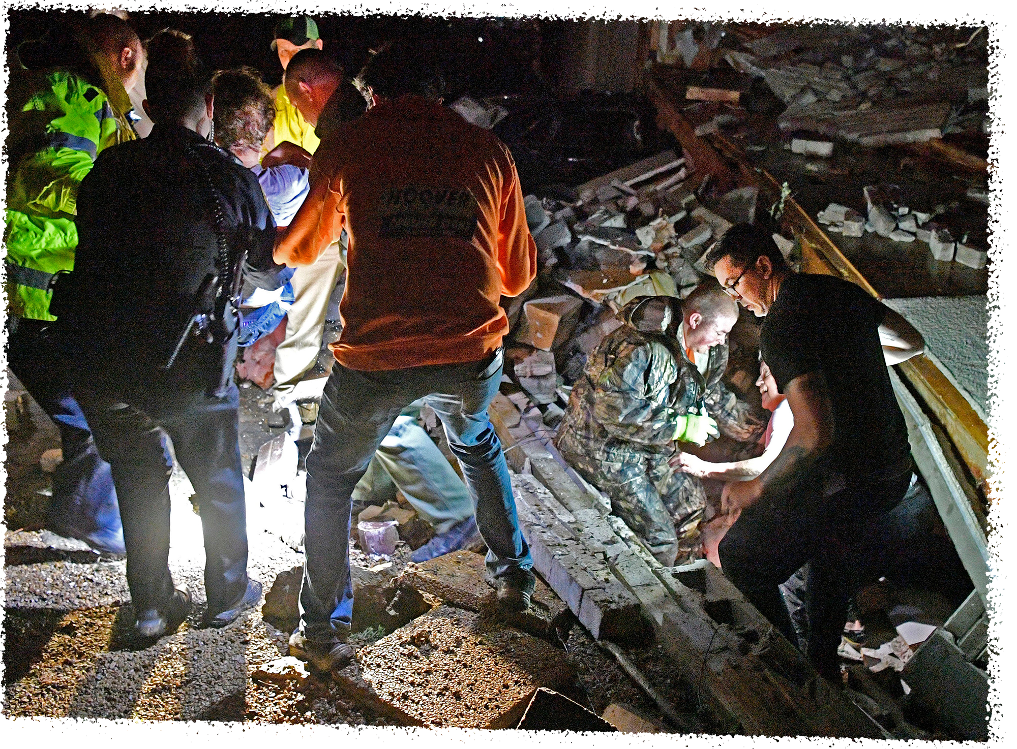 Bill Wallace gets help from rescue workers who freed him from his Barrett Drive home that collapsed on him and his wife Shirley trapping them under rubble.