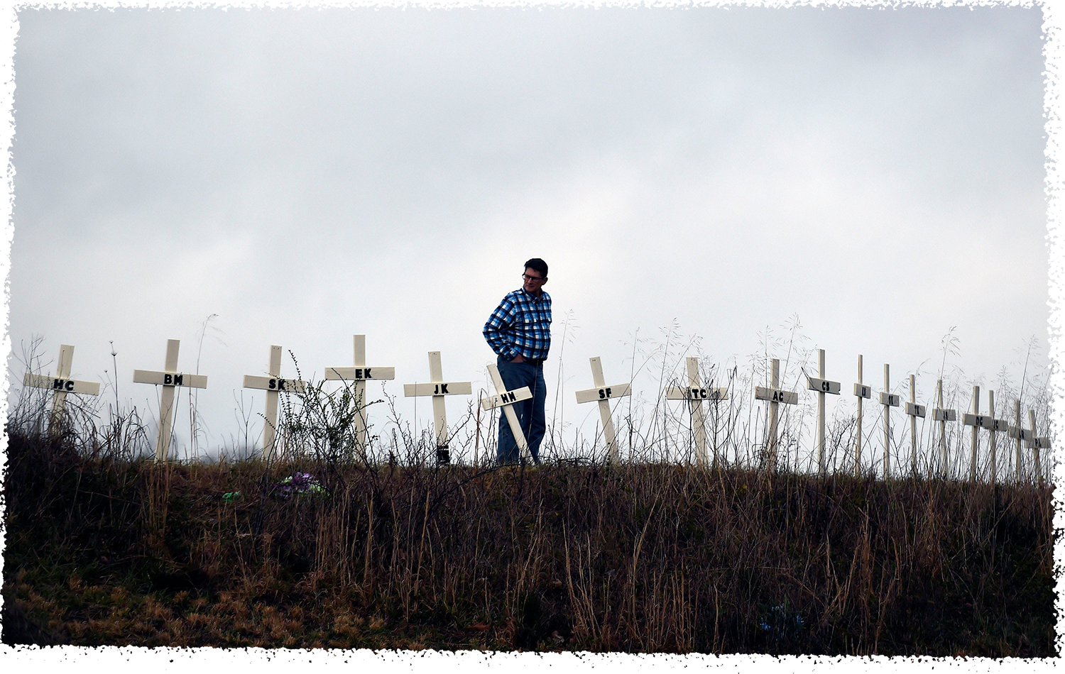 Allen Jingst looks at the 18 crosses erected on a small hill in memory of the victims who died in deadly tornadoes in Cookeville, Tenn.