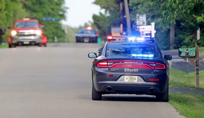A Milwaukee County Sheriff deputy sits on Fairy Chasm Road in Bayside on Thursday, June 17, 2021. Police were searching for two men during a village-wide shelter-in-place order after the suspects crashed a vehicle and evaded agents with the Drug Enforcement Administration.