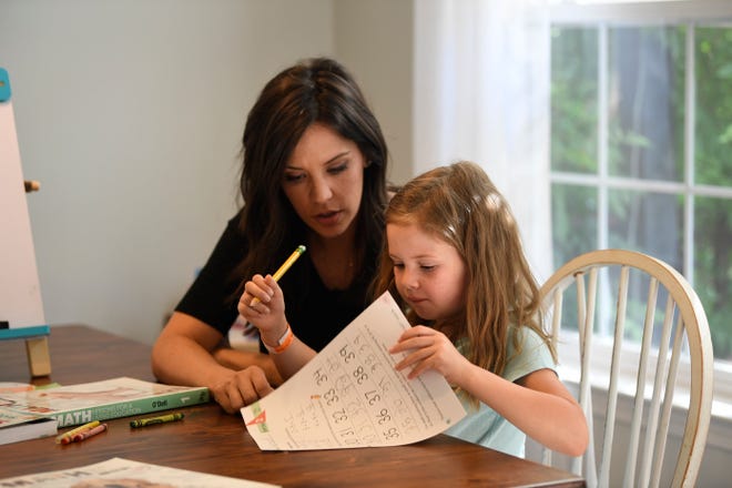 Erin Chesbro helps her daughter Gwyneth, 6, with her math homework in her home in Spring Hill, Tenn., Wednesday, June 16, 2021. 