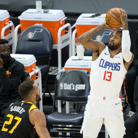 LA Clippers guard Paul George shoots the ball duri