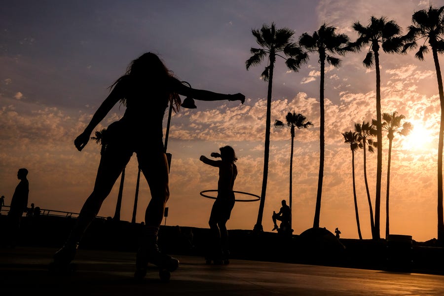 People are pictured as they workout near Venice Beach on Wednesday. An unusually early and long-lasting heat wave brought more triple-digit temperatures to a large swath of the Western United States, raising concerns that such extreme weather could become the new normal amid a decades-long drought.