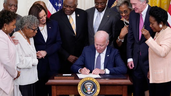 President Joe Biden signs the Juneteenth National 