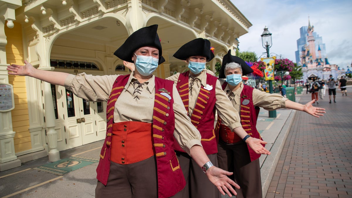 Disney cast members welcome visitors as Disneyland Paris parks reopen on June 17, 2021.
