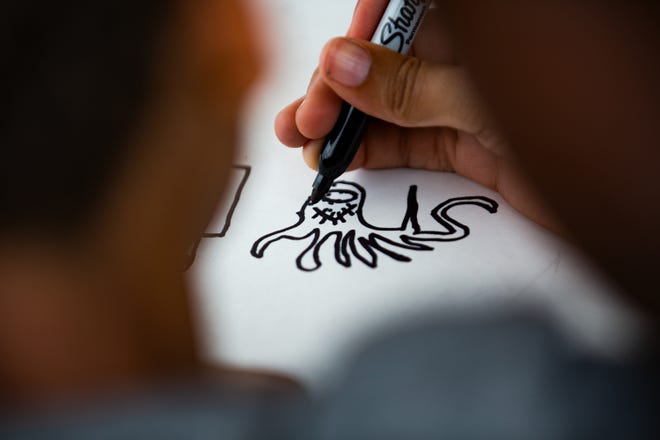 10-year-old Landon Hornbeak drew a scary monster at the Waterfront Park LVA Juneteenth camp on Friday, June 18, 2020.