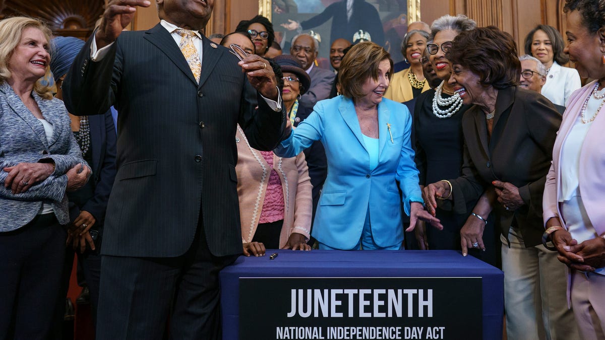 House Majority Whip James Clyburn, D-S.C., left, celebrates with Speaker of the House Nancy Pelosi and members of the Congressional Black Caucus after passage of the Juneteenth National Independence Day Act that creates a new federal holiday to commemorate June 19, 1865, when Union soldiers brought the news of freedom to enslaved Black people after the Civil War, at the Capitol in Washington, Thursday, June 17, 2021.