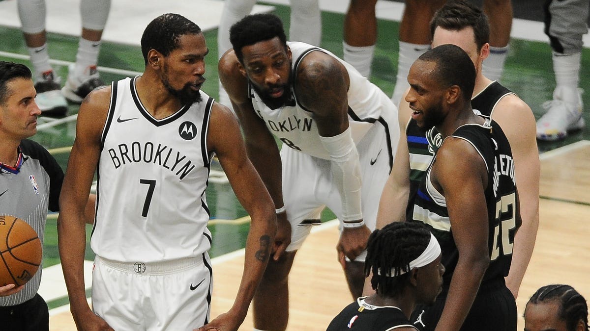 Brooklyn Nets forward Kevin Durant speaks with Milwaukee Bucks forward Khris Middleton after a hard foul on Bucks star Giannis Antetokounmpo during the fourth quarter of Game 6.