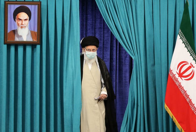 Supreme Leader Ayatollah Ali Khamenei arrives to cast his ballot on June 18, 2021, in Iran's presidential election.