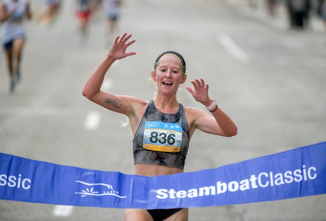 Lewistown native Ericka Waterman, now living in Golden, Colorado, reaches the finish line as the top female (22:28) in the 47th running of the 4-mile Steamboat Classic road race Saturday, June 19, 2021 through Downtown Peoria.