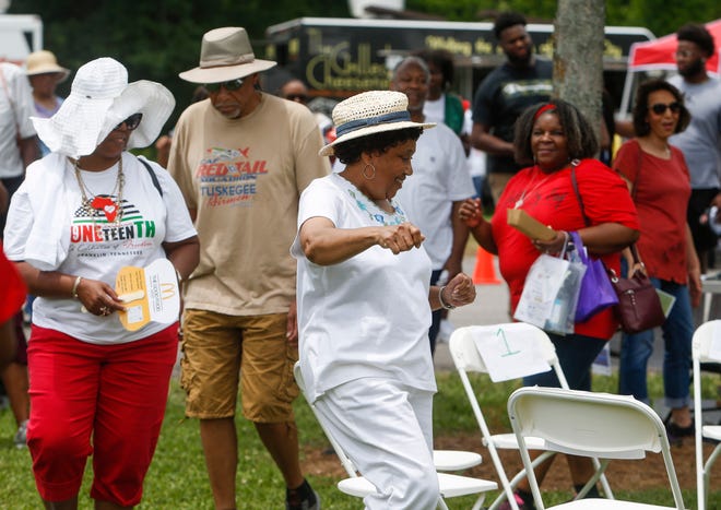 Eventgoers partake in a cake walk during the Juneteenth Celebration at Pinkerton Park in Franklin, Tenn., On Saturday, June 19, 2021. 