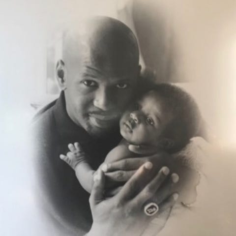 Jaren Jackson Jr. as a baby being held by his fath