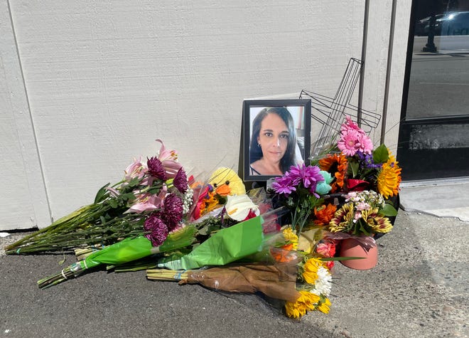 A memorial to Jennifer Davidson, 47, outside the Herbal Choices marijuana dispensary branch in North Bend on Saturday. She was the store's manager and one of three people allegedly killed the day before by Oen Nicholson, who surrendered in Wisconsin.