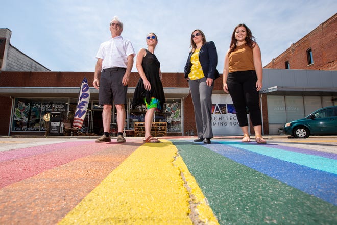 LGBTQ+ business owners, from left, Ken Liddle, Chelsea Smith, Nicole Revenaugh and Shelby Herring stand in NOTO's rainbow-colored crosswalk Thursday. The four local business owners said their identities encourage them to create open, inclusive business environments.