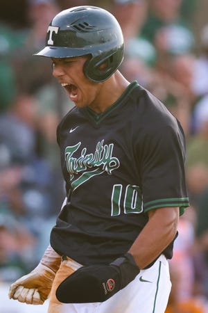 Trinity's Daylen Lile (10) celebrates scoring a run during the Trinity vs. McCracken County KHSAA State Baseball Tournament championship game on Saturday, June 19, 2021, at Whitaker Bank Ballpark in Lexington, Kentucky. Trinity won 10-5 in the fifth inning.
