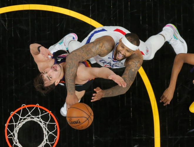 Phoenix Suns forward Dario Saric (20) and LA Clippers center DeMarcus Cousins (15) battle for a rebound during Game 1 of the Western Conference Finals in Phoenix June 20, 2021.