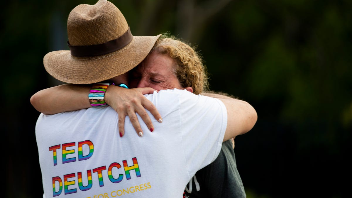 U.S. Rep. Debbie Wasserman Schultz of Florida is comforted after a truck drove into a crowd of people during a Pride parade in Wilton Manors near Fort Lauderdale on Saturday.
