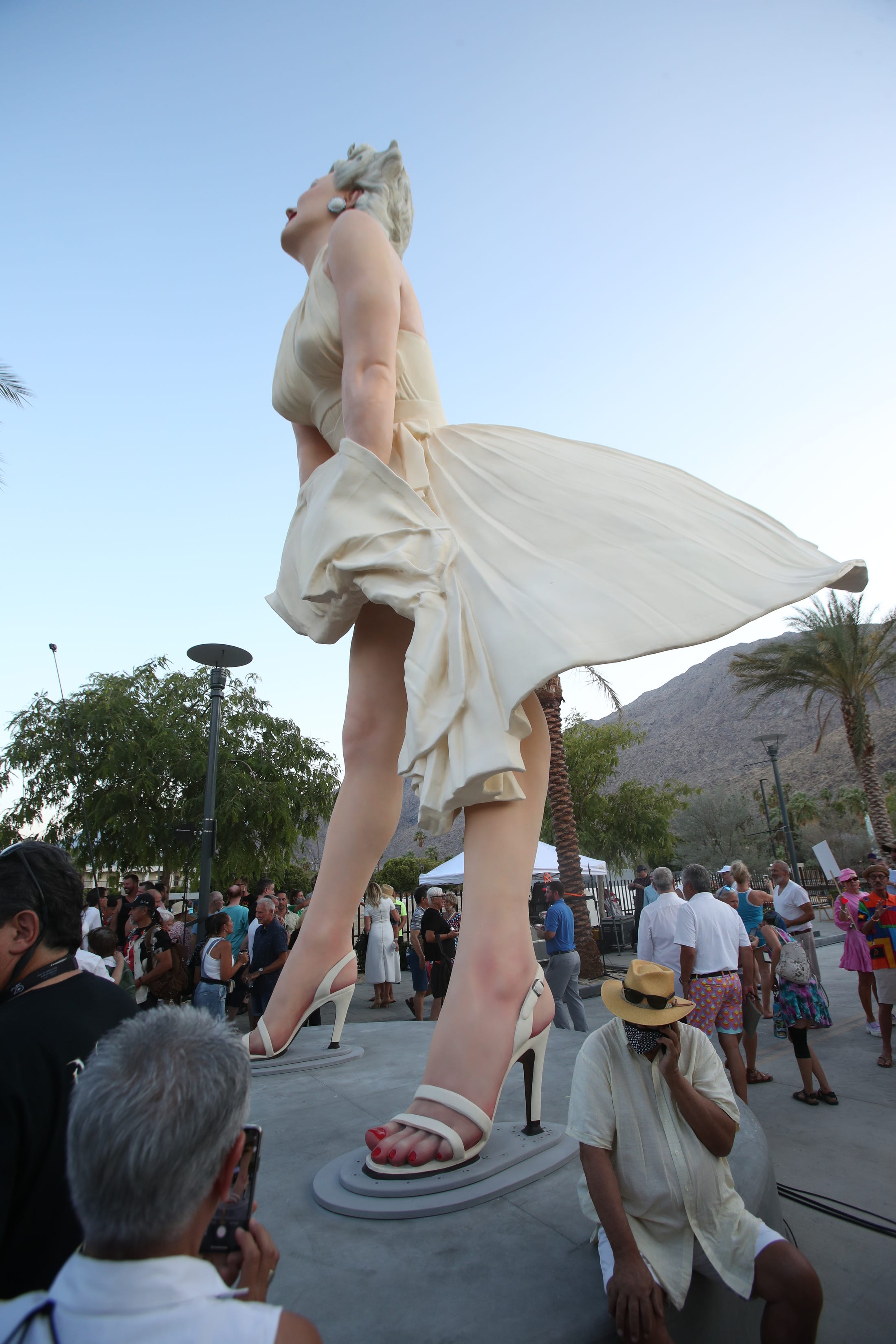 People gather for the unveiling of the "Forever Marilyn" statue in downtown Palm Springs, Calif., on June 20, 2021.