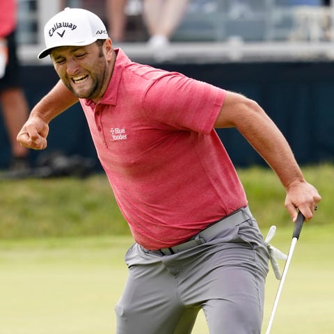 Jon Rahm reacts to his birdie putt on the 18th gre