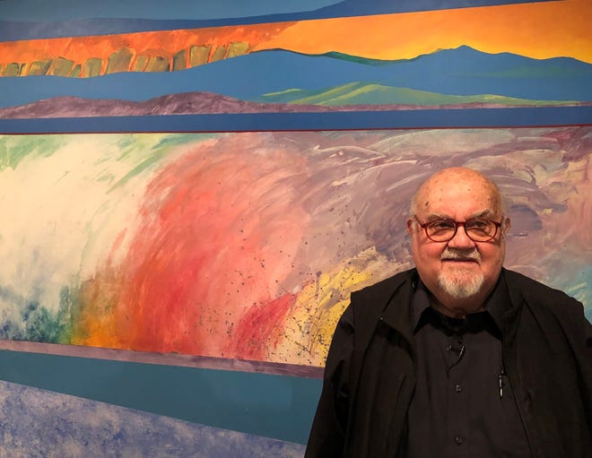 Goshen artist Abner Hershberger stands in front of his 1977 painting, "Monte Acuto Region," now on display at the Midwestern Museum of American Art in Elkhart.