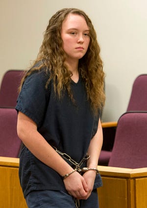 FILE - Meagan Grunwald, enters the courtroom after a recess on April 17, 2014, during her preliminary hearing in Provo, Utah. Grunwald will serve up to 30 years in prison for her involvement with the death of a police officer as a teenager, a sentence that comes after the state Supreme Court overturned her original conviction. Grunwald's boyfriend fired the fatal shots, but her role as a 17-year-old getaway driver originally got her a sentence of up to life in prison in the slaying of Utah County Sheriff's Sgt. Cory Wride. (Rick Egan/The Salt Lake Tribune via AP, Pool, File)