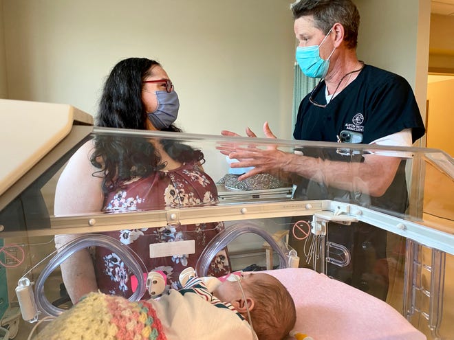 Dr. C. Armitage Harper talks with mom Marcie Fontecchio after examining her daughter Lindley for retinopathy of prematurity. Harper is one of only 40 specialists in that disorder in the world.