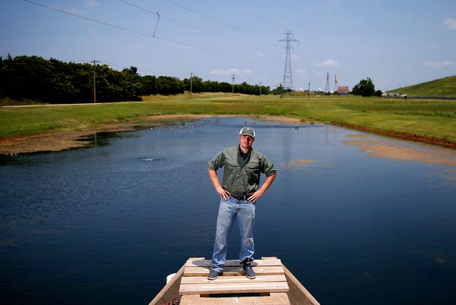Oklahoma City fisheries biologist John Rayfield poses for a photo at the H.B. Parson Fish Hatchery in Oklahoma City last month. A Georgia native, Rayfield worked in the Bahamas, Alaska and on the Atlantic Ocean before accepting the job in Oklahoma.