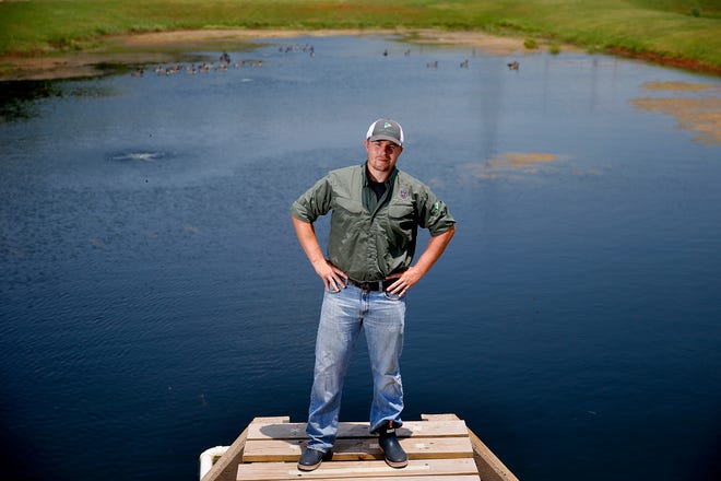 Fish biologist John Rayfield poses for a photo at the H.B. Parson Fish Hatchery in Oklahoma City last month. Rayfield took over as OKC's fisheries biologist in April 2020.