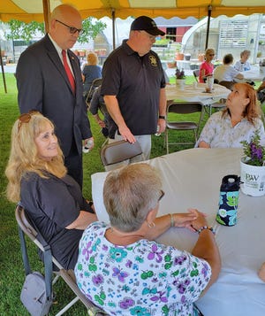 DA Tim Cruz and Sheriff Joe McDonald talk with people at the Plymouth County Triad annual luncheon.