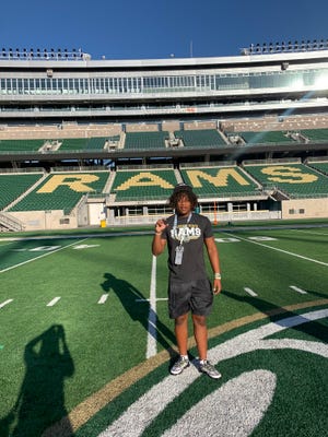 Joseph Sipp Jr. poses for a photo taken by his mother at Canvas Stadium during his official recruiting visit to Colorado State on Friday, June 18, 2021, in Fort Collins, Colo.