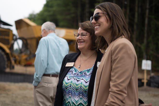 Henderson County commissioner Rebecca McCall, left, poses for a photo at the groundbreaking ceremony for the new Jabil Healthcare facility on June 24, 2021 in Flat Rock.