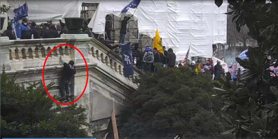 surveillance image from the U.S. Capitol shows a person whom prosecutors believe to be Iowan Doug Jensen scaling the outside of the building during the Jan. 6, 2021, riot in Washington, D.C.