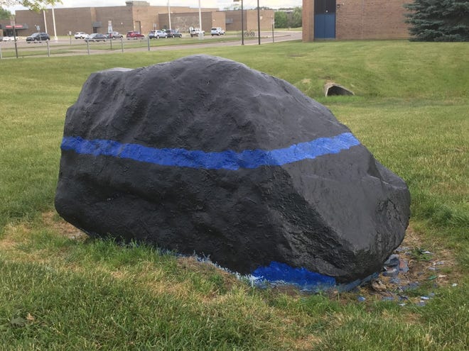 The rock outside Salem High School was recently painted with a thin blue line in memory of former Plymouth-Canton Schools Liaison Officer Ed Jagst, who died June 21.